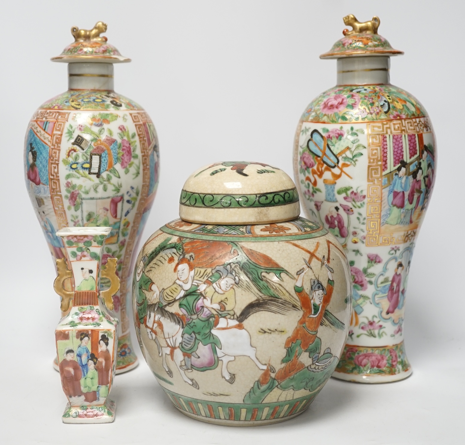 A pair of 19th century Chinese famille rose vases and covers, a similar small vase and a a famille verte crackle glaze jar, tallest 31cm